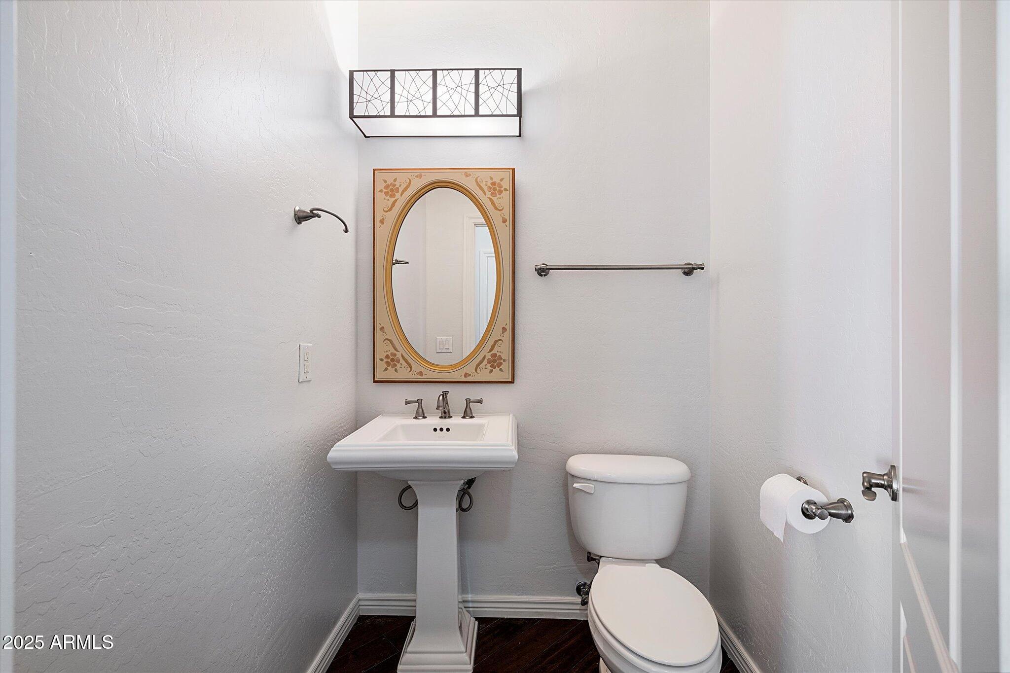 970 South Henry Lane Gilbert, AZ 85296 - Photo 11 of 51 a bathroom with a toilet sink and mirror