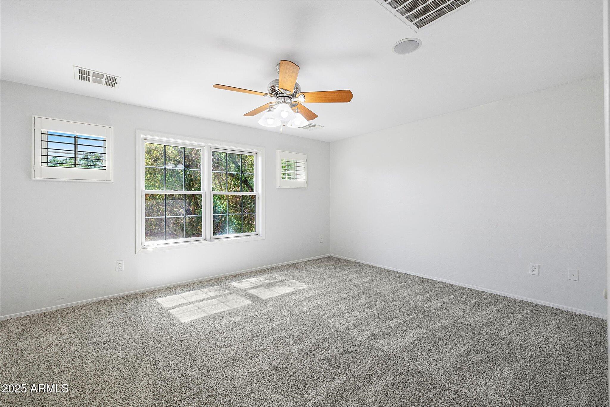 970 South Henry Lane Gilbert, AZ 85296 - Photo 12 of 51 an empty room with windows and fan