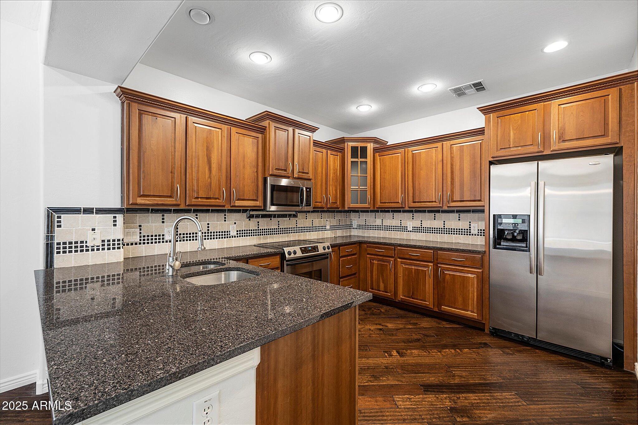 970 South Henry Lane Gilbert, AZ 85296 - Photo 2 of 51 a kitchen with stainless steel appliances granite countertop a sink a stove and refrigerator