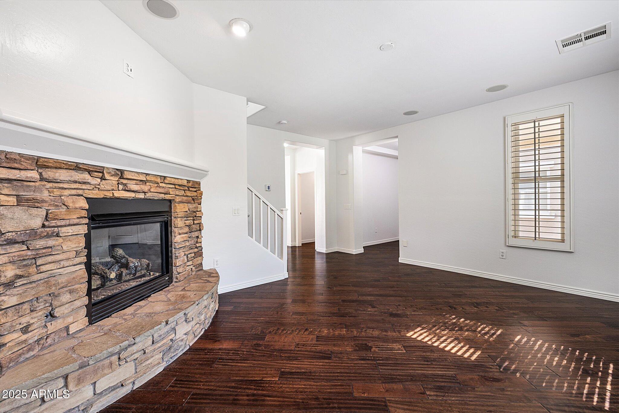 970 South Henry Lane Gilbert, AZ 85296 - Photo 33 of 51 a view of an empty room with wooden floor fireplace and a window