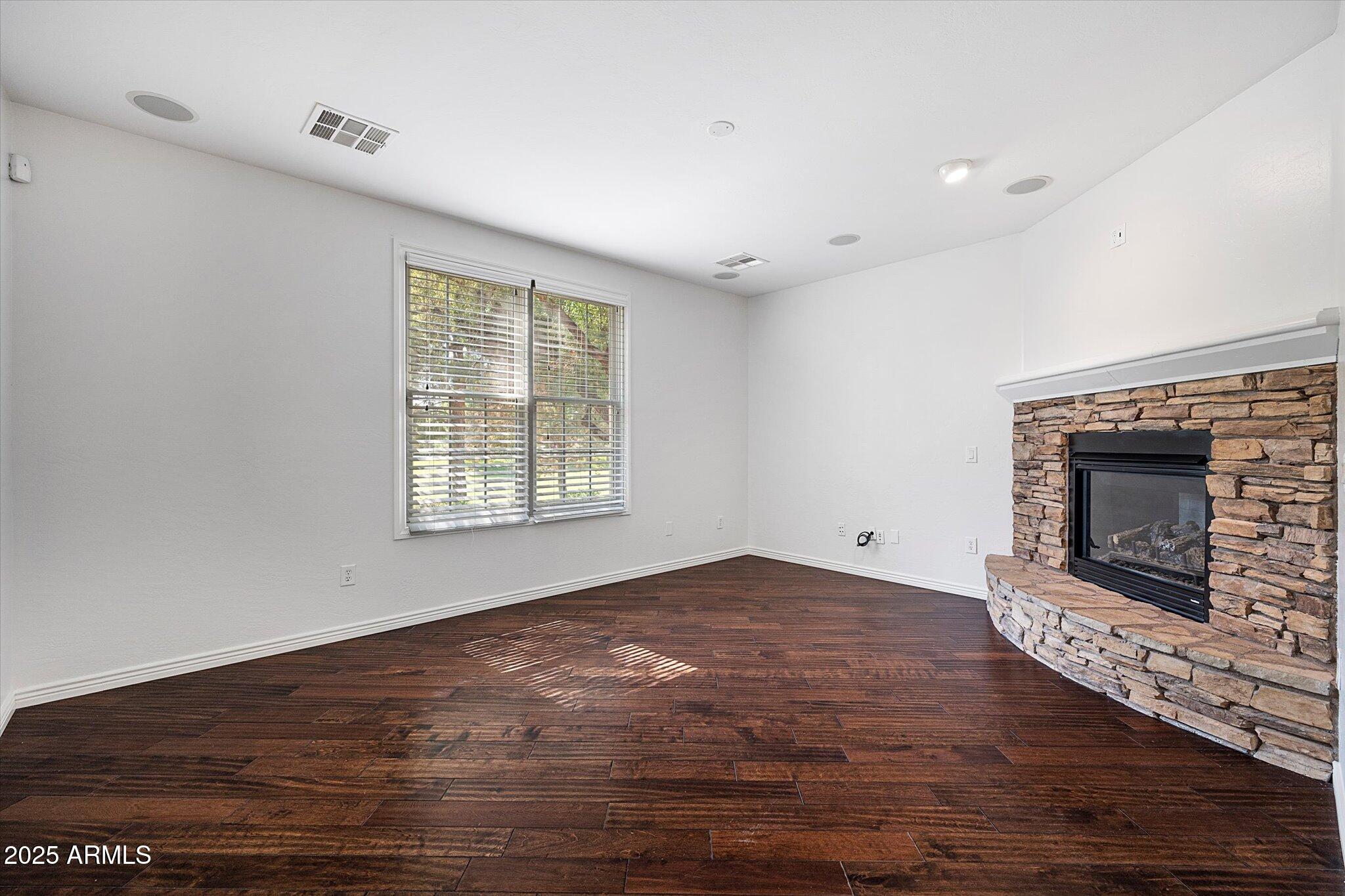 970 South Henry Lane Gilbert, AZ 85296 - Photo 34 of 51 a view of empty room with wooden floor and fireplace