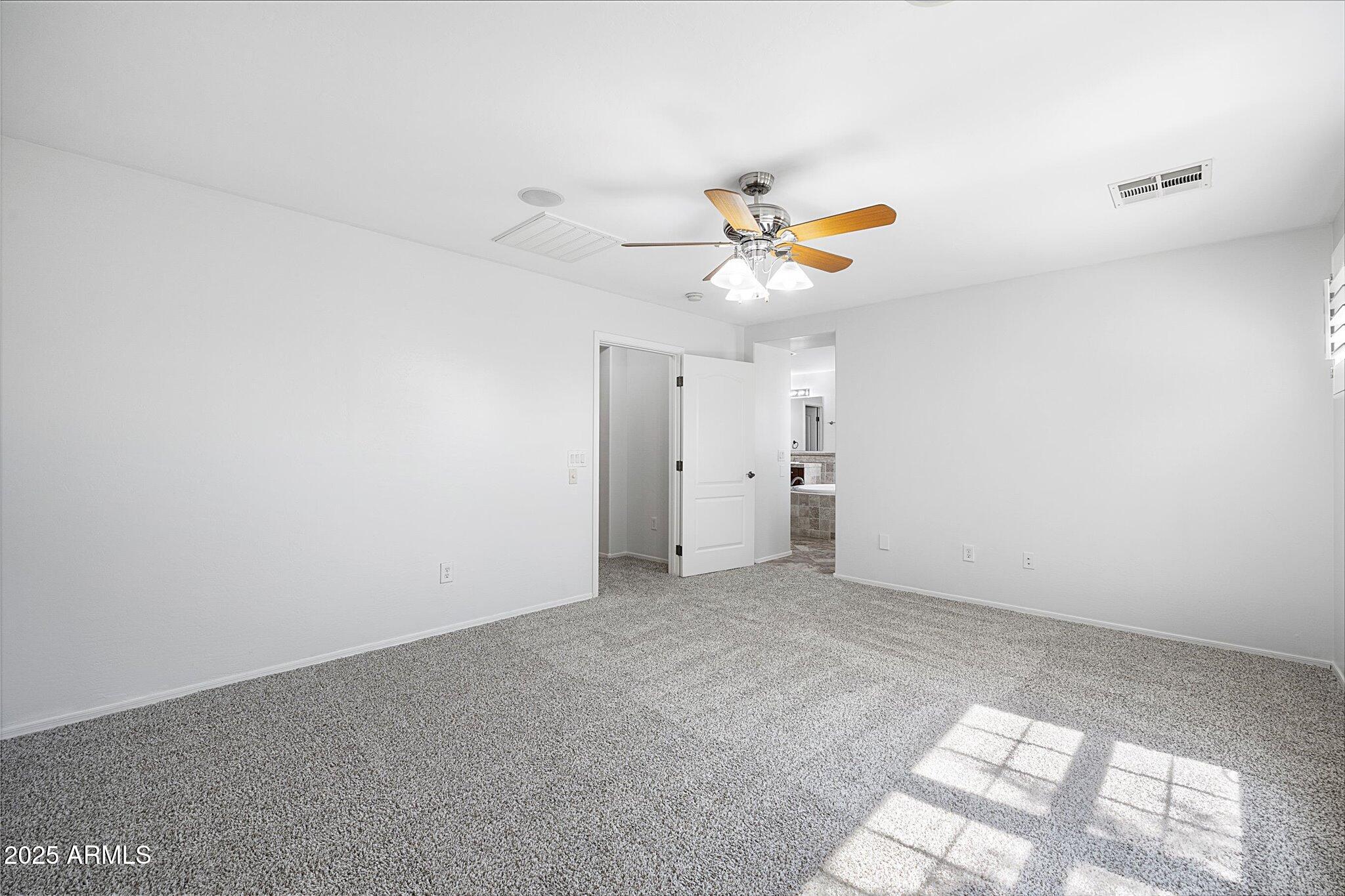 970 South Henry Lane Gilbert, AZ 85296 - Photo 35 of 51 an empty room with a ceiling fan and window
