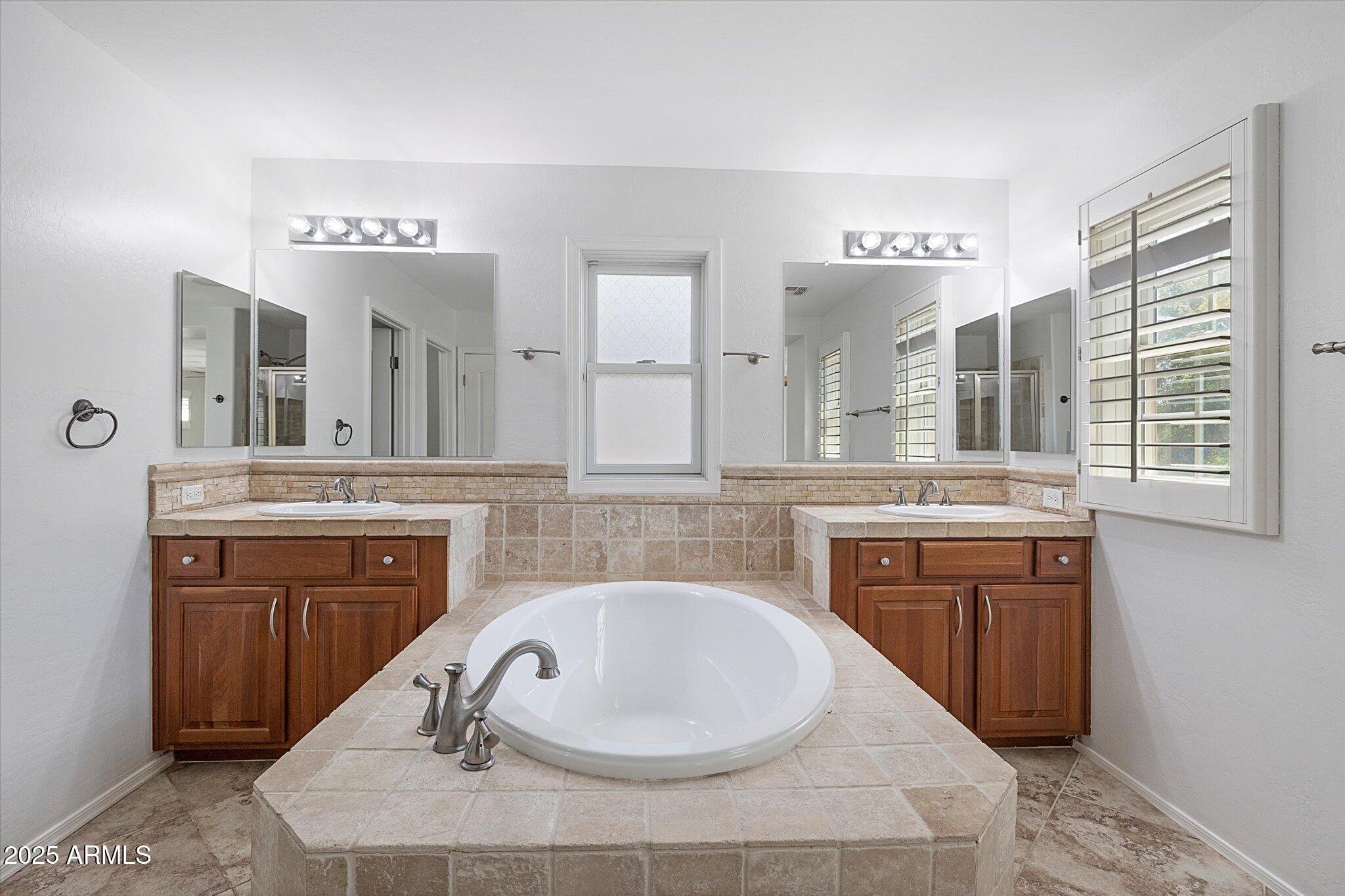 970 South Henry Lane Gilbert, AZ 85296 - Photo 38 of 51 a en suite bathroom with a granite countertop sink and a mirror