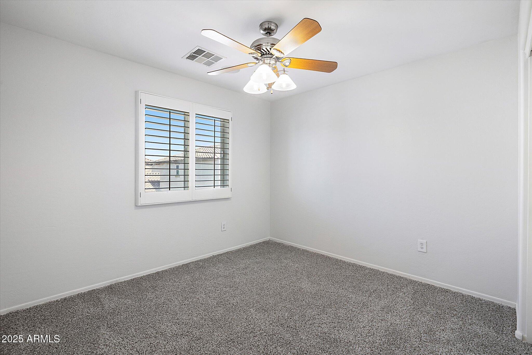970 South Henry Lane Gilbert, AZ 85296 - Photo 40 of 51 an empty room with a window and a ceiling fan