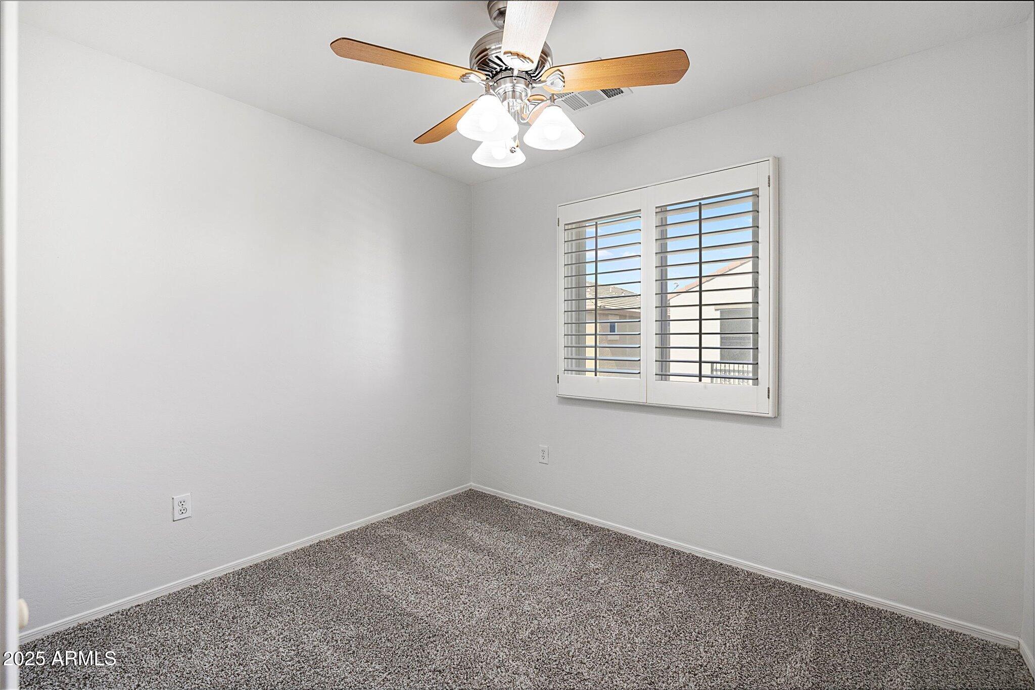 970 South Henry Lane Gilbert, AZ 85296 - Photo 41 of 51 an empty room with a window and a fan