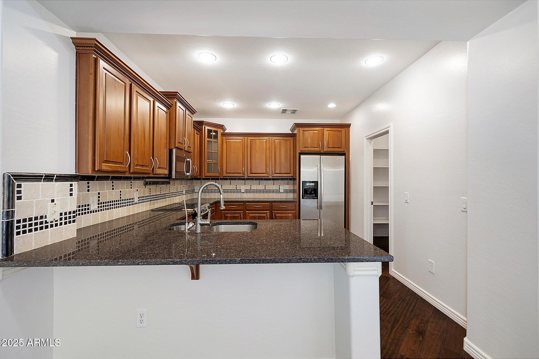 970 South Henry Lane Gilbert, AZ 85296 - Photo 44 of 51 a kitchen with stainless steel appliances granite countertop a sink refrigerator and cabinets