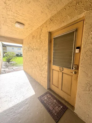 a view of a door and wooden floor
