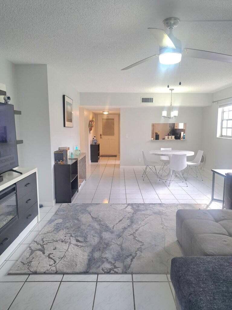 1700 Dover Road, Unit 113A Delray Beach, FL 33445 - Photo 3 of 13 a living room with furniture and view of kitchen