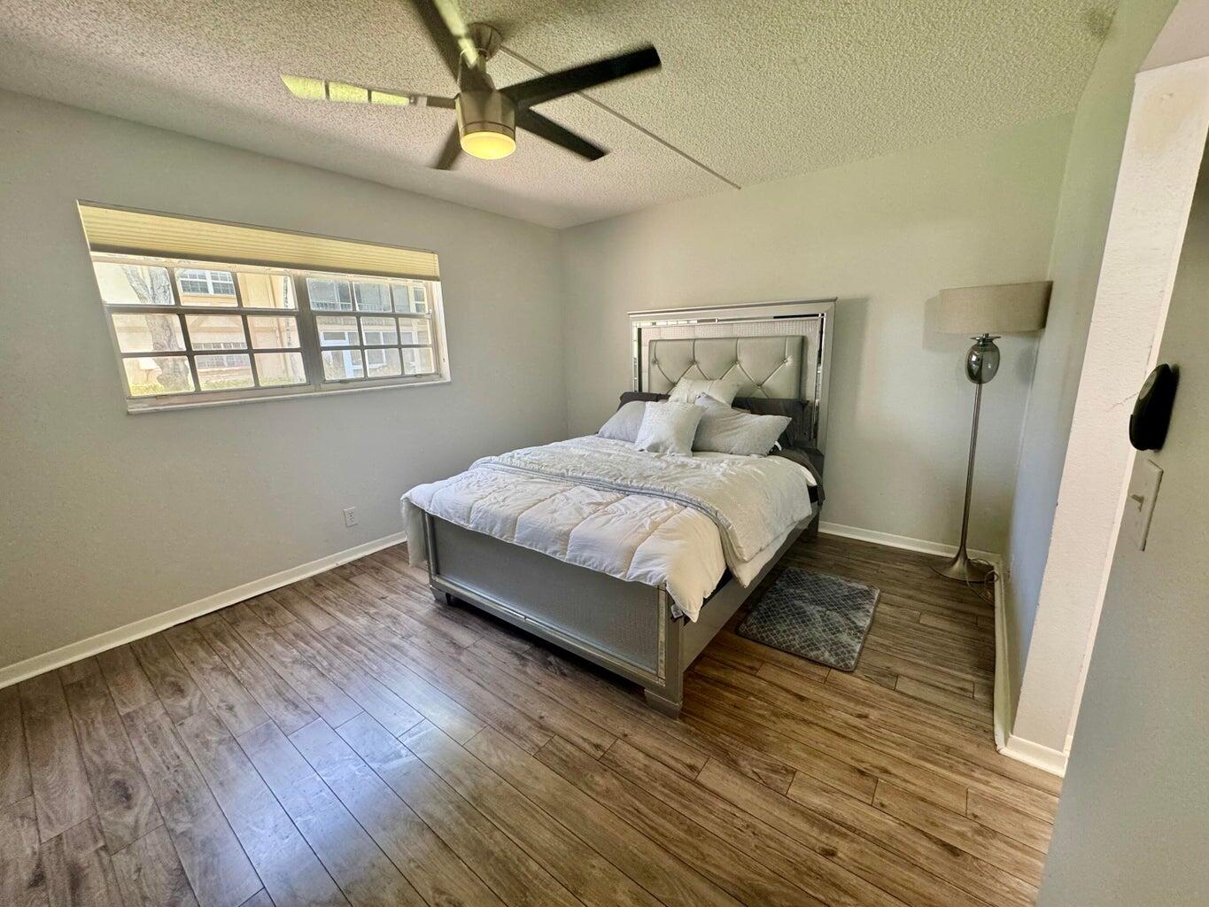 1700 Dover Road, Unit 113A Delray Beach, FL 33445 - Photo 6 of 13 a bedroom with a bed and window