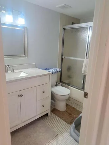 a white toilet sitting next to a bathroom sink