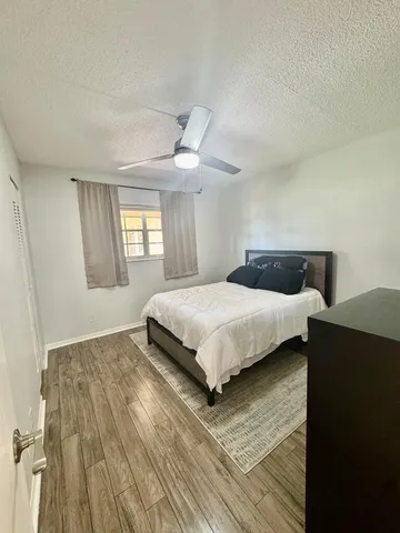 a bedroom with a bed and window