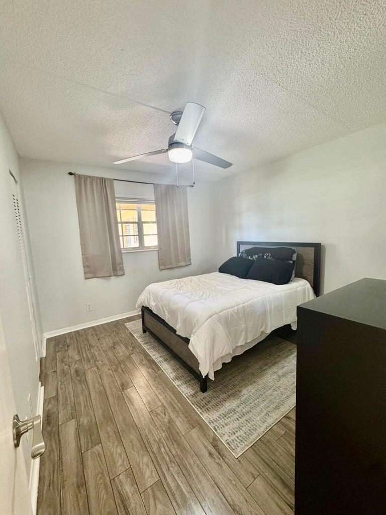 1700 Dover Road, Unit 113A Delray Beach, FL 33445 - Photo 10 of 13 a bedroom with a bed and window