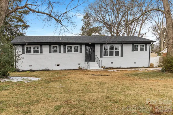 a house that has a tree in front of it