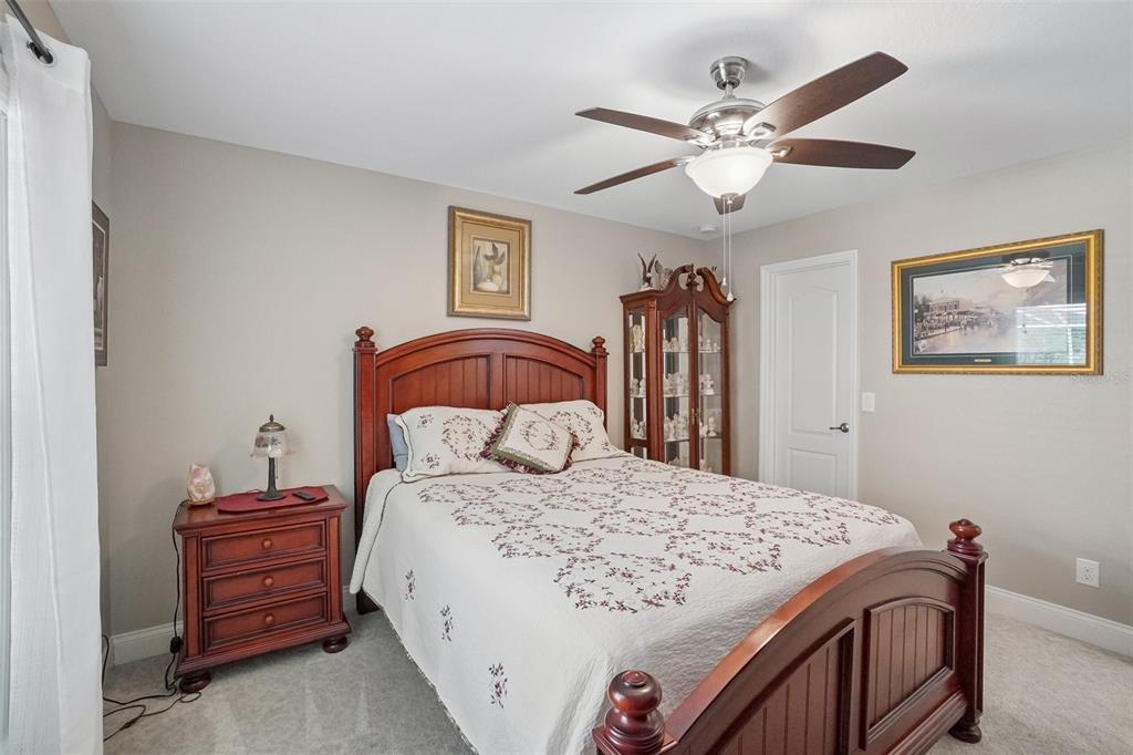3934 Connersville Road Bartow, FL 33830 - Photo 49 of 81 a bedroom with a large bed and a chandelier