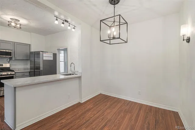 a view of a kitchen with wooden floor and a sink