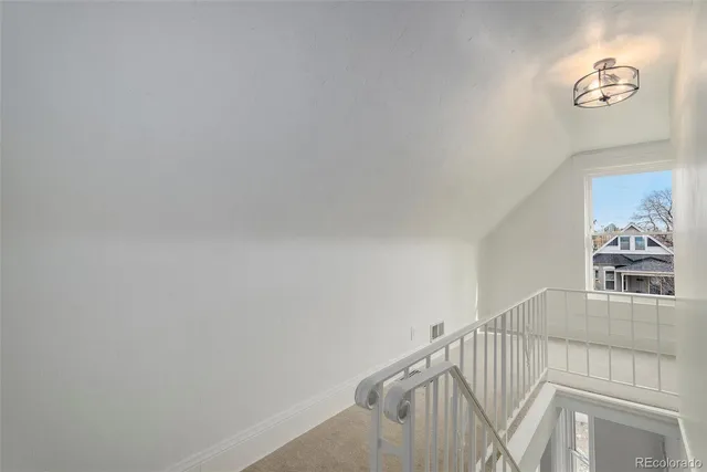 a view of a hallway with stairs