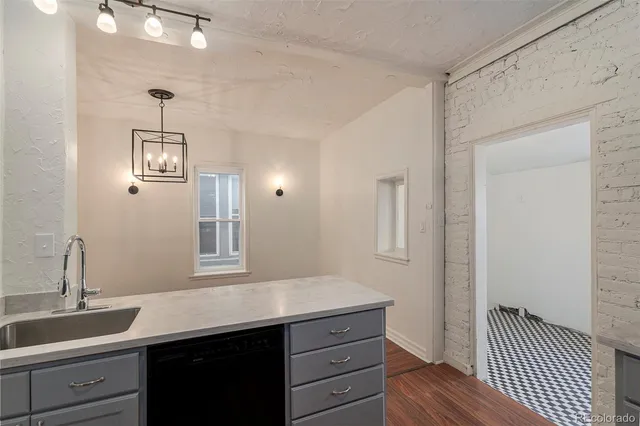 a hallway with a sink and wooden floor