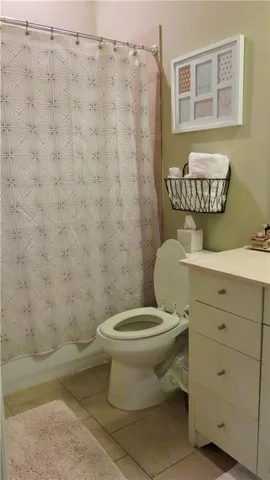 a bathroom with a toilet sink and shower
