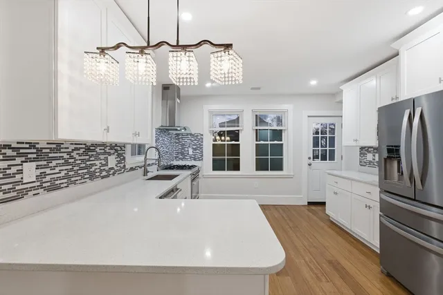 a kitchen with stainless steel appliances a sink stove and refrigerator