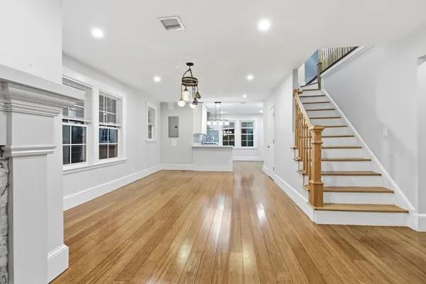 a view of wooden floor and windows in a room