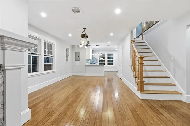 a view of wooden floor and windows in a room