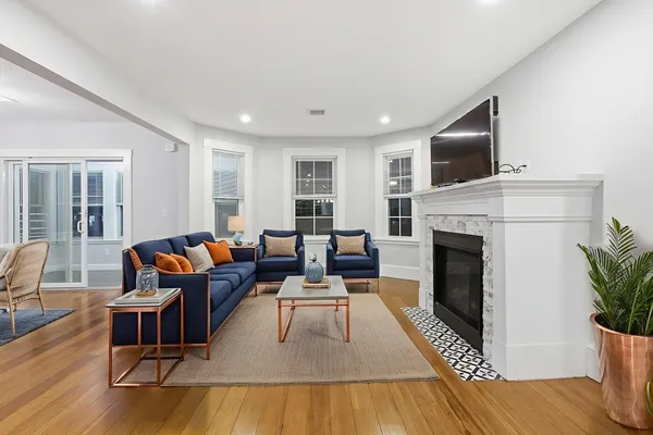 a living room with furniture fireplace and flat screen tv