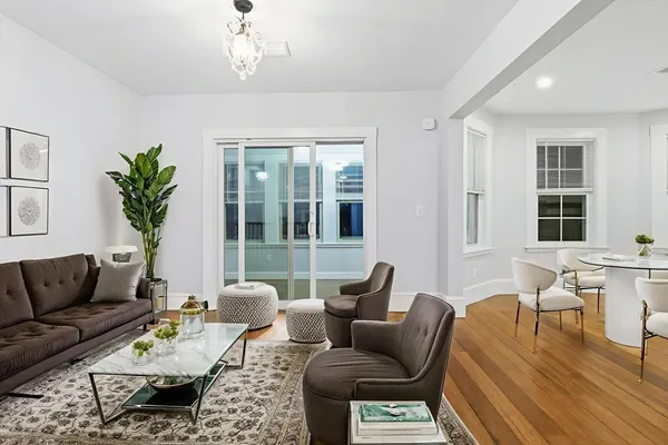 a living room with furniture and a chandelier