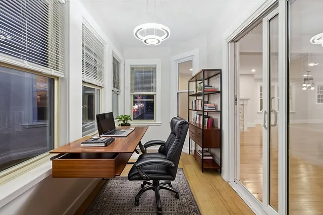 a view of a workspace with furniture and a window