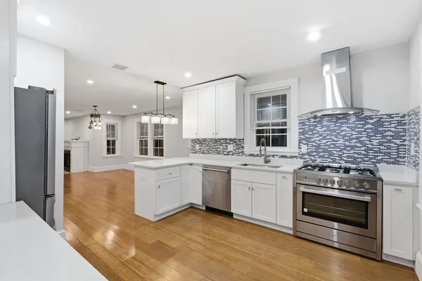 a kitchen with stainless steel appliances granite countertop a stove and a refrigerator