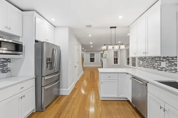 a kitchen with stainless steel appliances a refrigerator sink and microwave