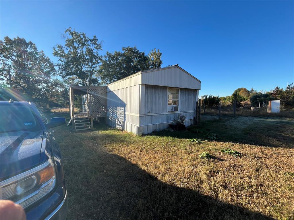 162 County Road 162, Unit 3 Elkhart, TX 75839 - Photo 1 of 13 a view of a house with a yard