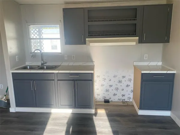 a kitchen with a sink and a refrigerator