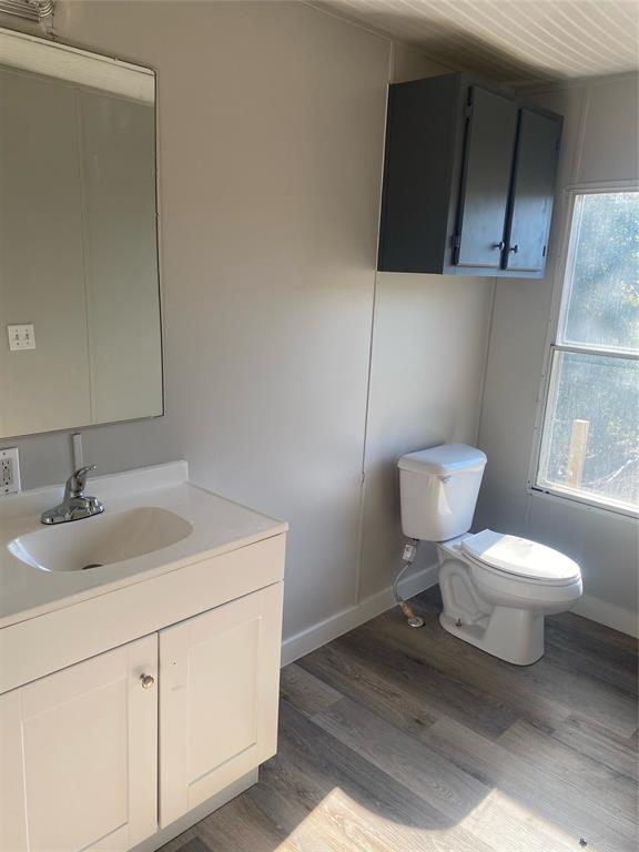162 County Road 162, Unit 3 Elkhart, TX 75839 - Photo 12 of 13 a bathroom with a toilet sink and mirror