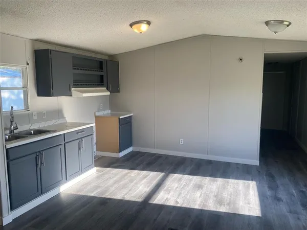 a kitchen with a sink and a microwave