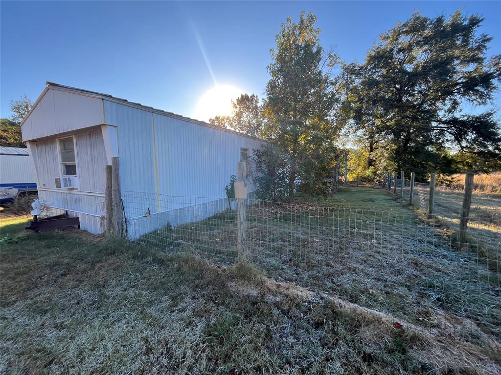 162 County Road 162, Unit 3 Elkhart, TX 75839 - Photo 2 of 13 a backyard of a house with lots of green space