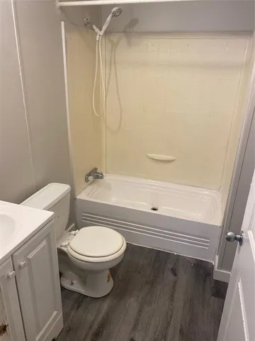 a bathroom with a toilet and a shower