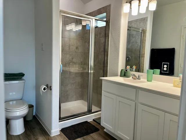 a bathroom with a shower sink and toilet