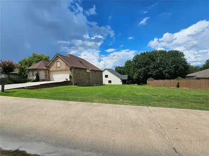a view of house with backyard and garden