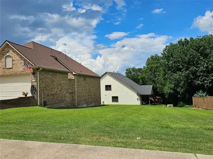 a view of a yard in front view of a house