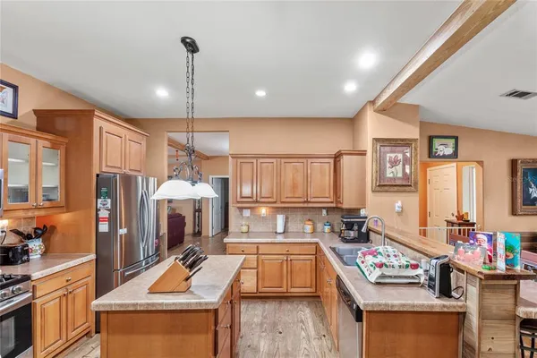a kitchen that has a lot of cabinets a sink and a stove