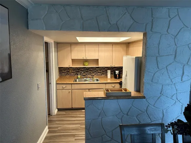 a kitchen with stainless steel appliances a refrigerator and cabinets
