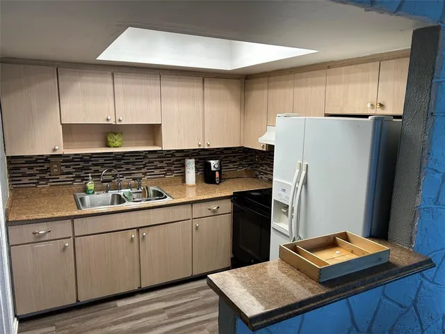 a kitchen with a sink appliances and cabinets