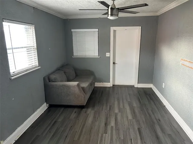 a living room with furniture and a hard wood floor