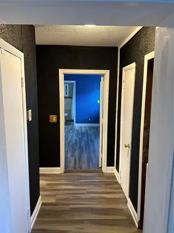 a view of a hallway with wooden floor and a hallway