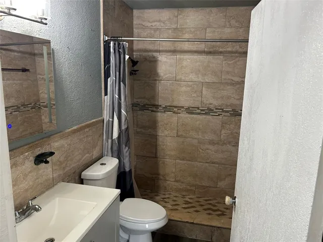 a bathroom with a toilet and shower