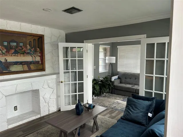 a living room with furniture and a potted plant
