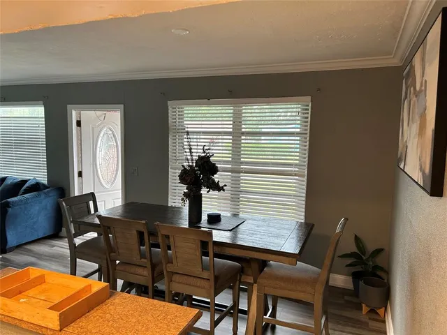 a view of a dining room with furniture and window