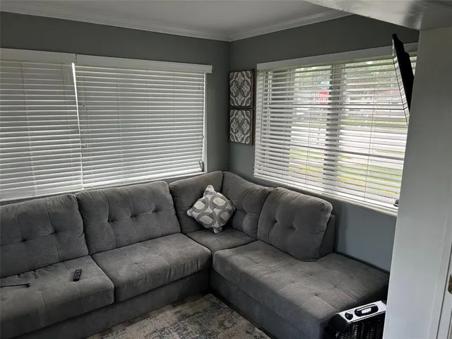 a living room with furniture and a window