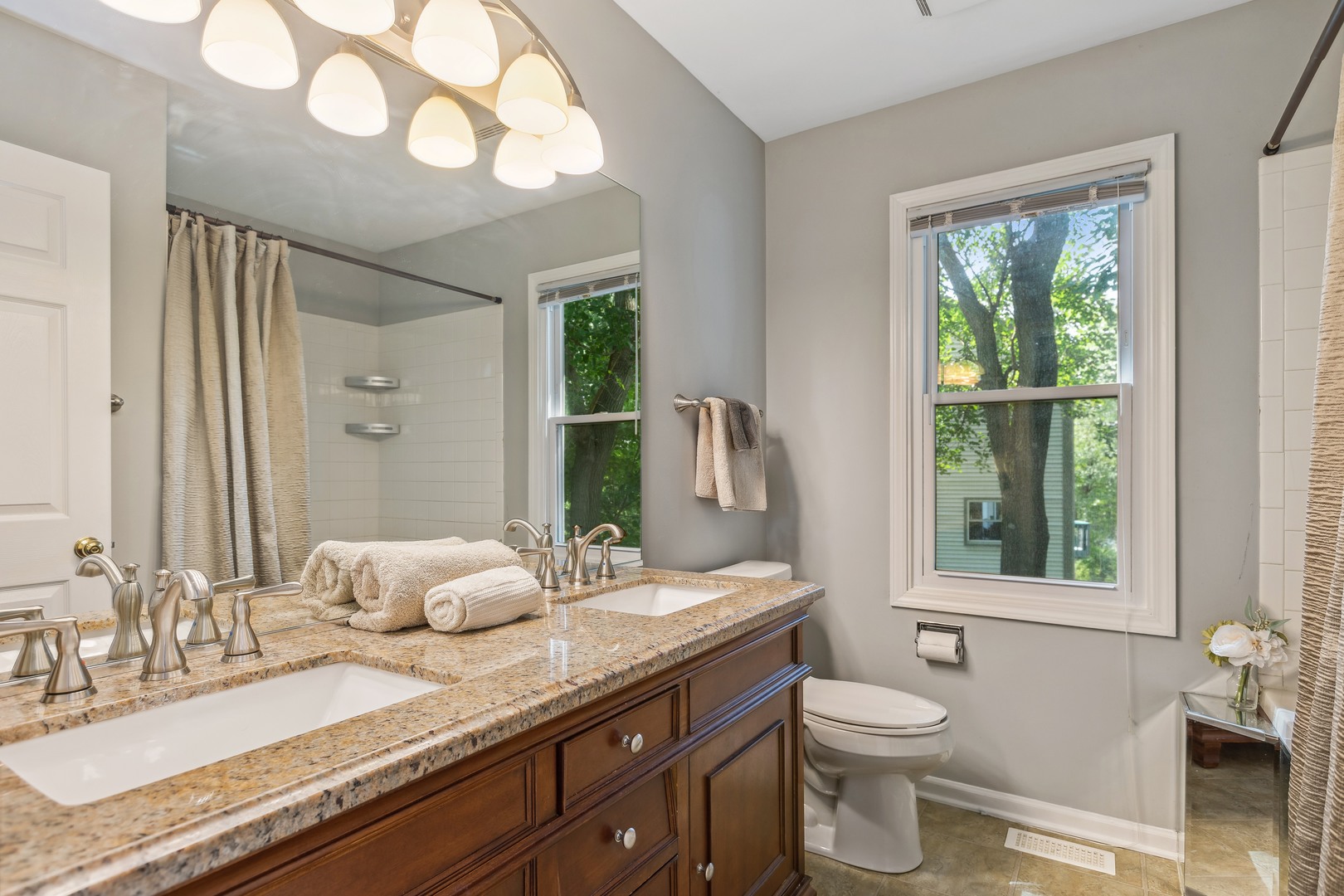 409 Hunters Way Fox River Grove, IL 60021 - Photo 12 of 22 a bathroom with a granite countertop sink mirror vanity and toilet