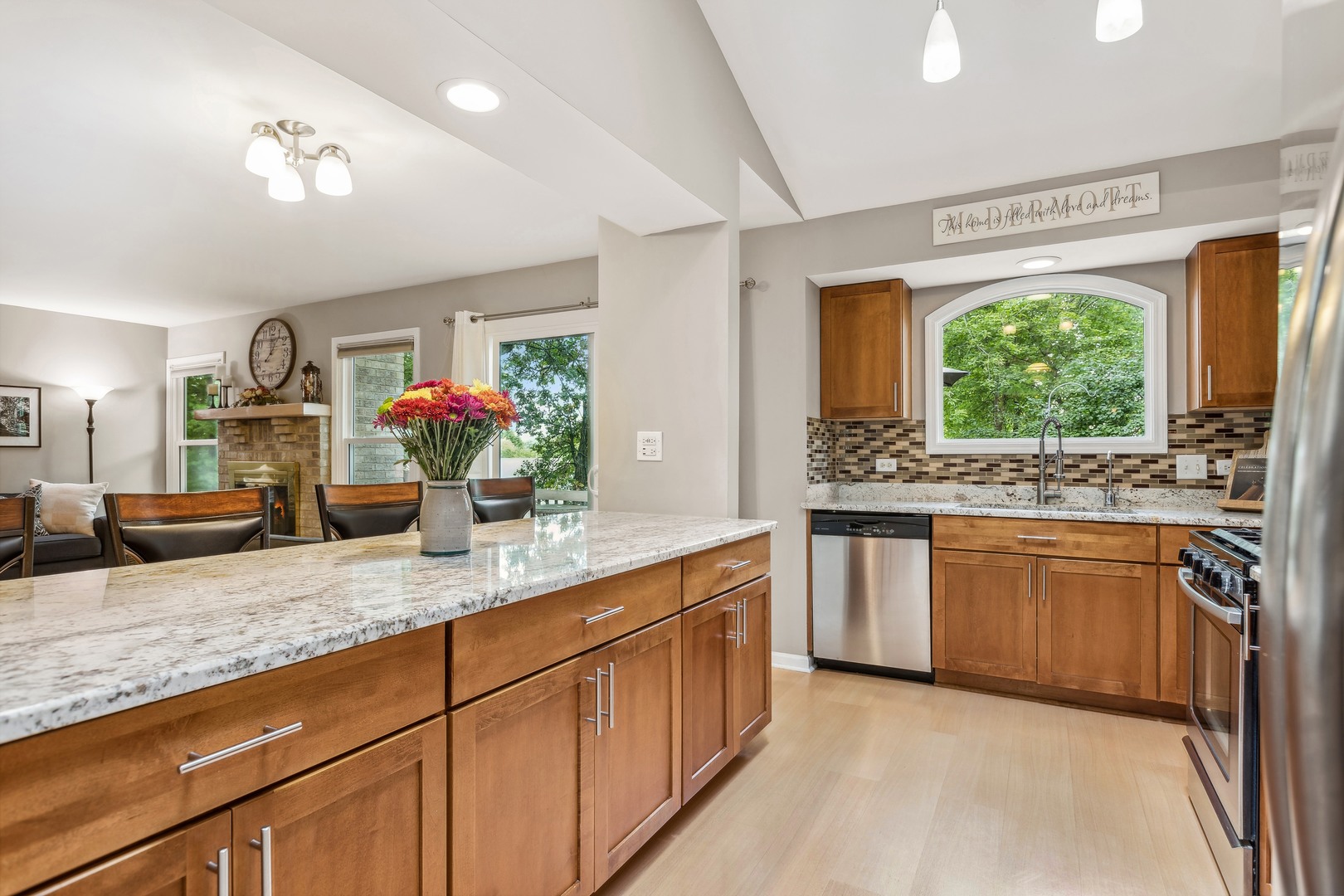 409 Hunters Way Fox River Grove, IL 60021 - Photo 3 of 22 a kitchen with stainless steel appliances granite countertop a sink and a large window